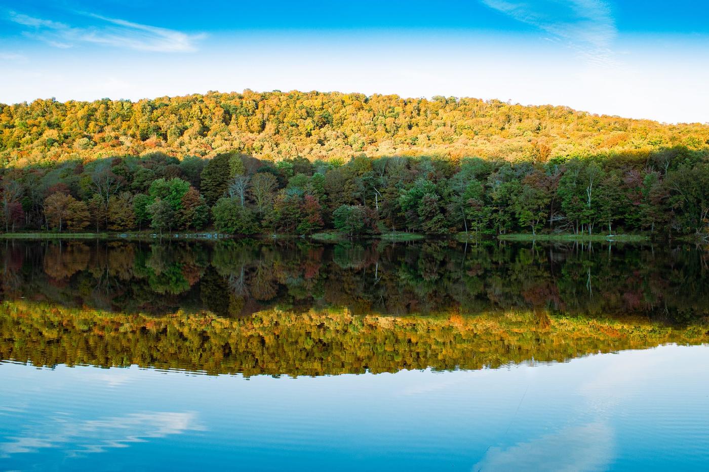 Fall foliage reflected on a quiet Finger Lake