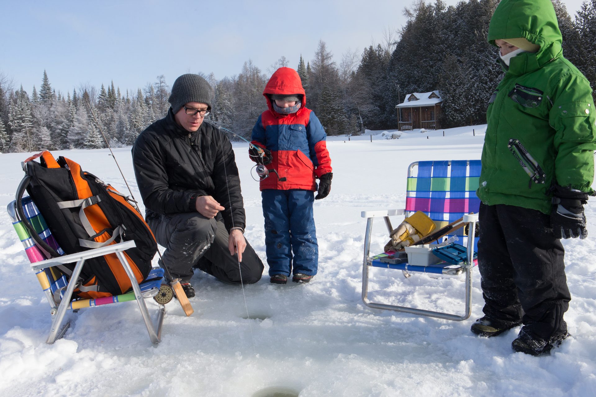 Ice fishing on a frozen Finger Lake in winter